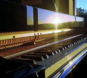piano keyboard reflecting setting sun